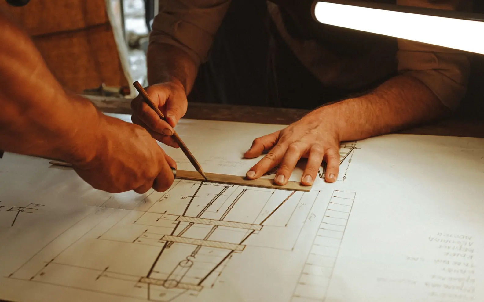 Architectural professionals coordinating dimensions and notes on a construction drawing set