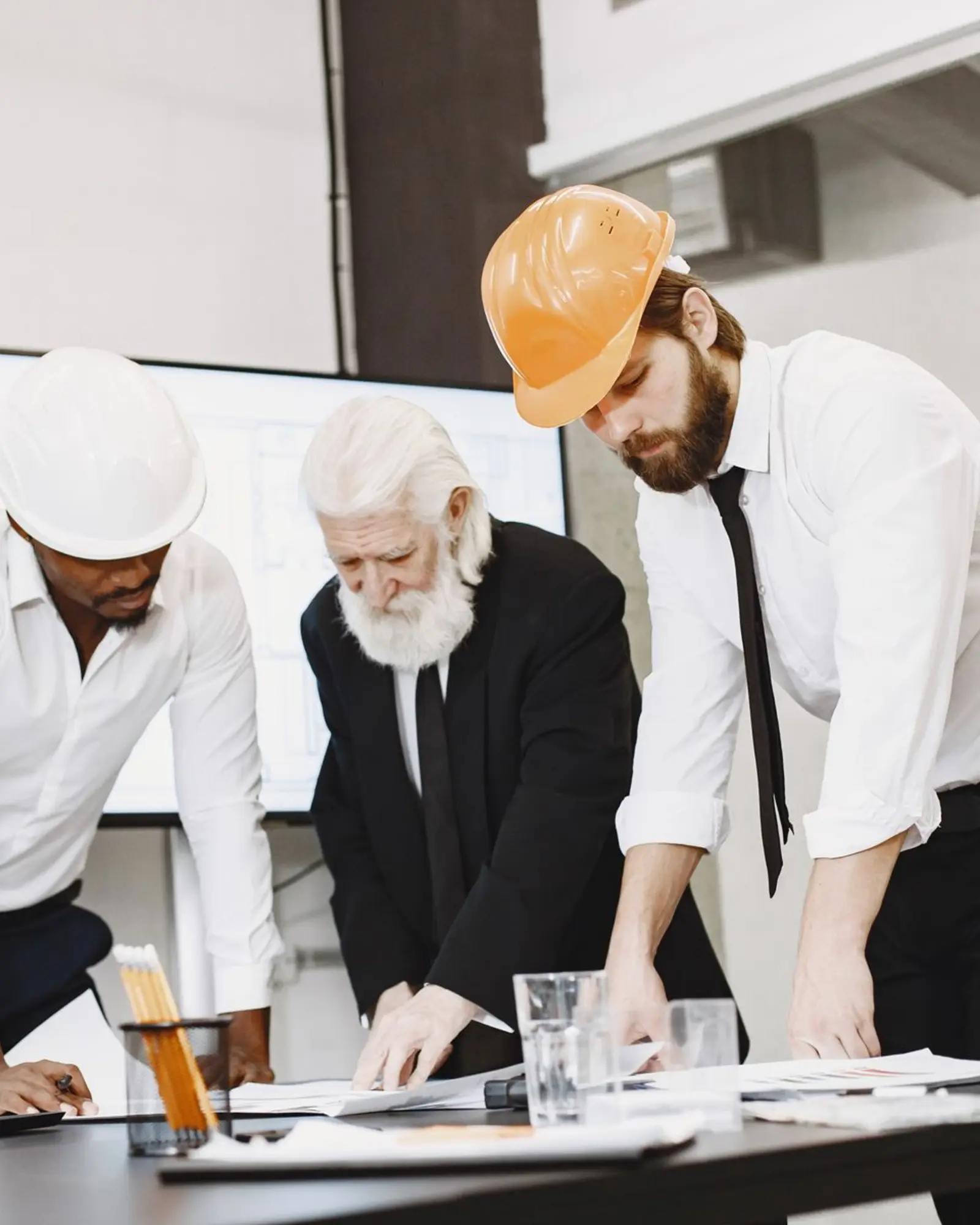 Architects and engineers reviewing project plans and documented outcomes together