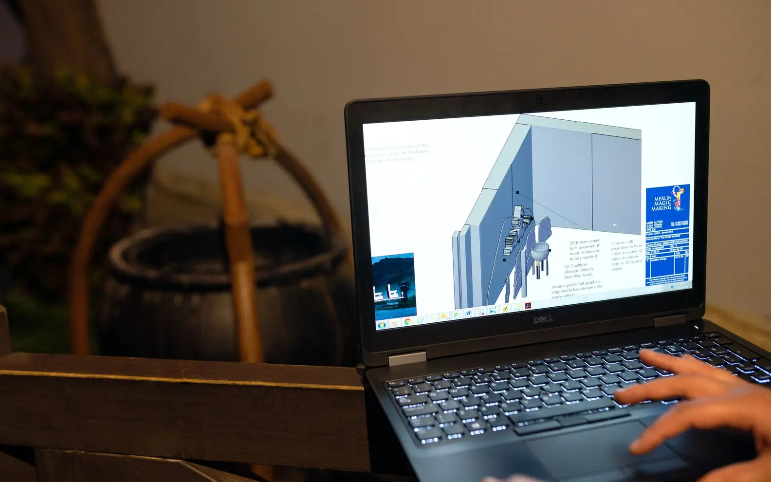 Mechanical engineer developing a three-dimensional CAD design on a laptop