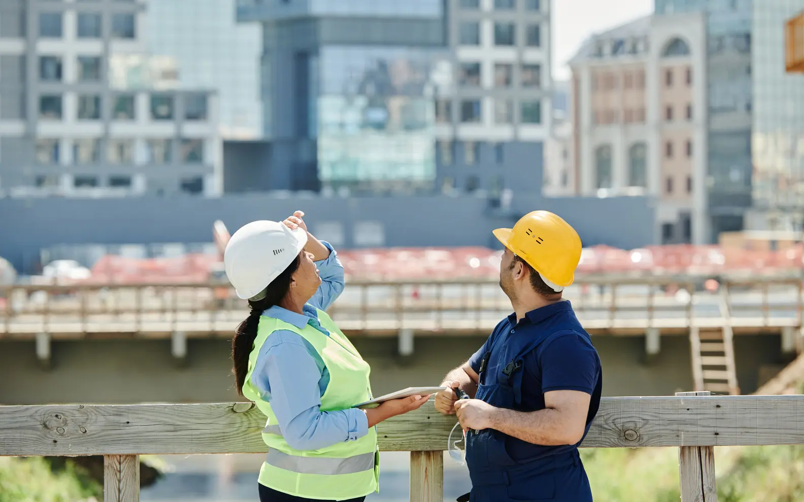 Two construction professionals discussing site conditions during an active project review