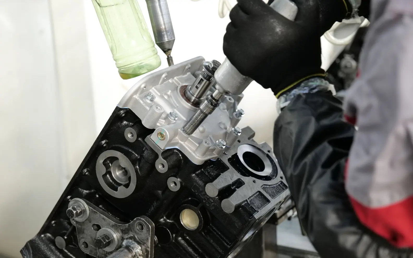 Technician assembling precision components into a mechanical engine block